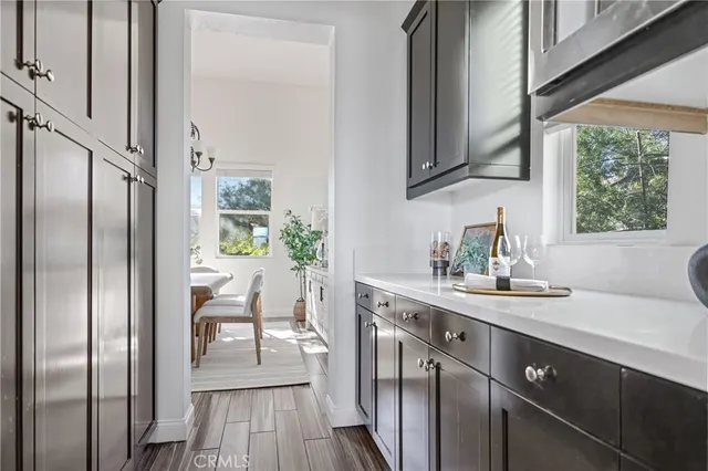 a living room with furniture a chandelier and a flat screen tv
