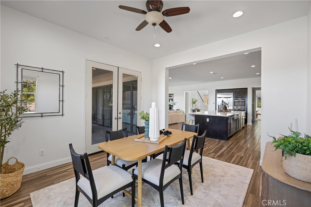 24910 Old Stone Way Stevenson Ranch, CA 91381 - Photo 27 of 67 a view of a dining room with furniture and a potted plant