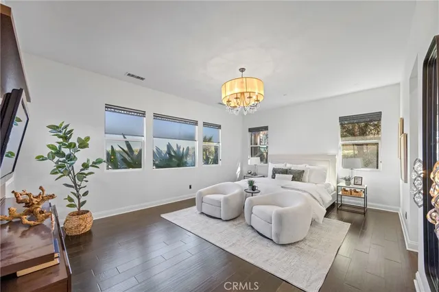 a bathroom with a sink a mirror and a potted plant