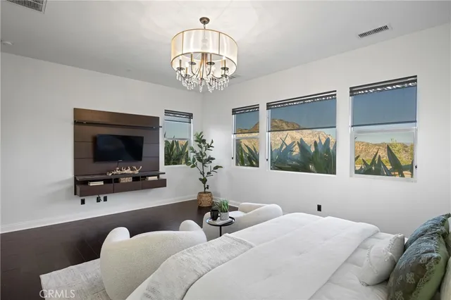 a bedroom with a bed and a potted plant