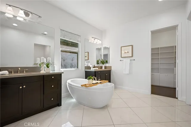 a bathroom with a sink toilet double vanity and shower