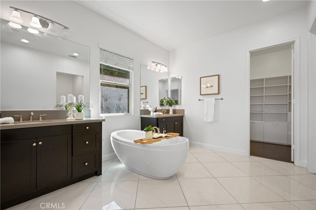 24910 Old Stone Way Stevenson Ranch, CA 91381 - Photo 30 of 67 a living room with furniture a window and kitchen view