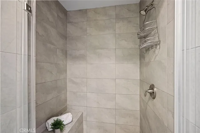 a living room with furniture two window and a potted plant