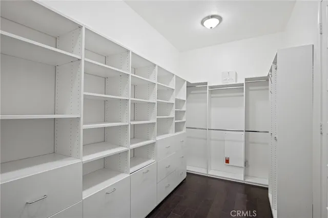 a view of a livingroom with furniture and a dining table with wooden floor