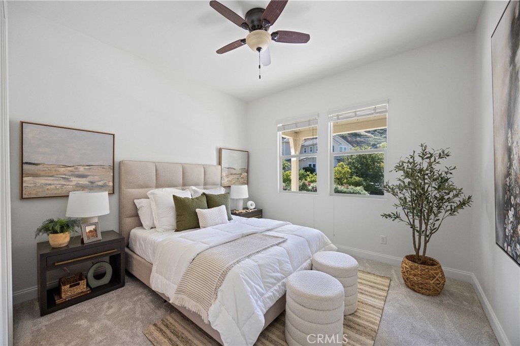 24910 Old Stone Way Stevenson Ranch, CA 91381 - Photo 36 of 67 a bedroom with a bed and a potted plant