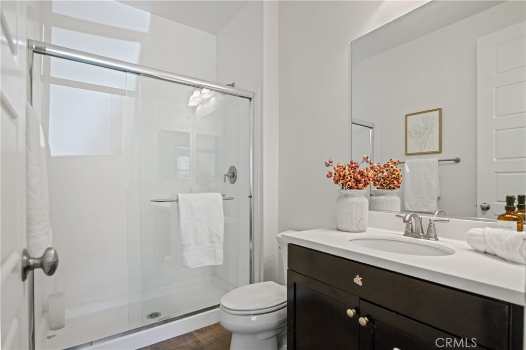 24910 Old Stone Way Stevenson Ranch, CA 91381 - Photo 37 of 67 a bathroom with a sink toilet double vanity and shower