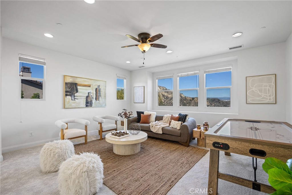 24910 Old Stone Way Stevenson Ranch, CA 91381 - Photo 39 of 67 a living room with furniture two window and a potted plant