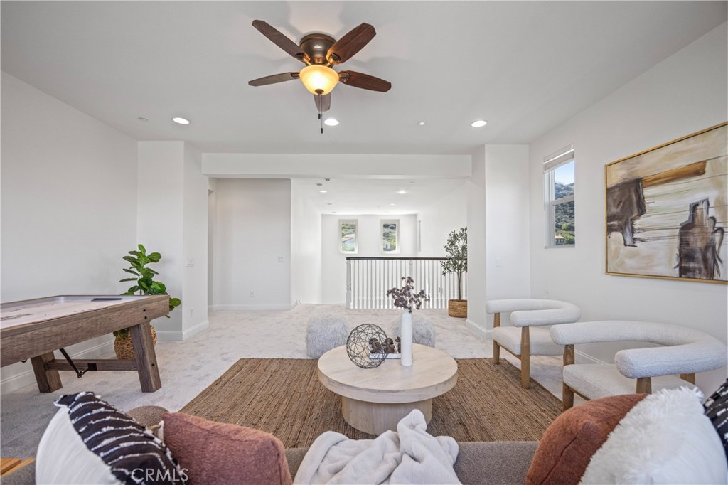 24910 Old Stone Way Stevenson Ranch, CA 91381 - Photo 41 of 67 a view of a livingroom with furniture and a dining table with wooden floor