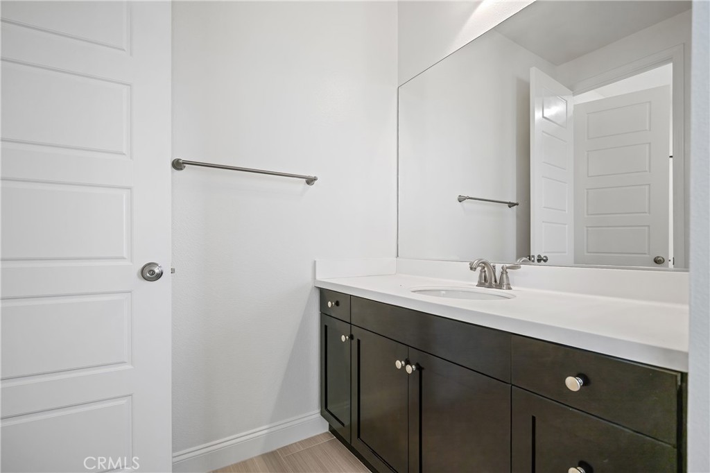 24910 Old Stone Way Stevenson Ranch, CA 91381 - Photo 43 of 67 a bathroom with a double vanity sink and mirror