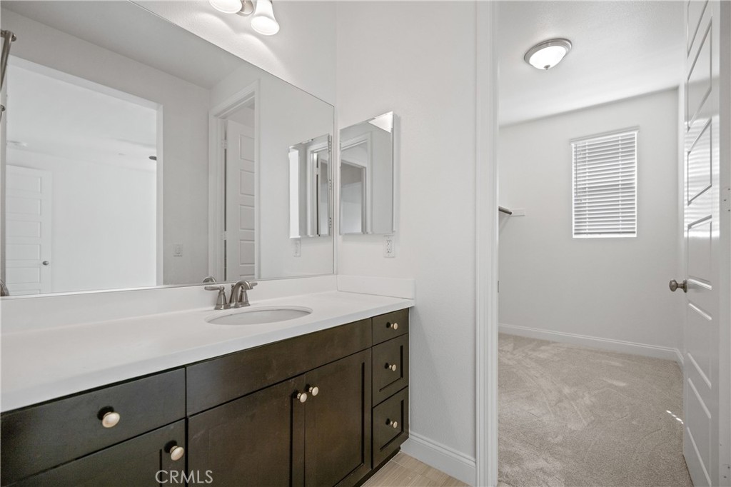 24910 Old Stone Way Stevenson Ranch, CA 91381 - Photo 45 of 67 a bathroom with a sink and a mirror