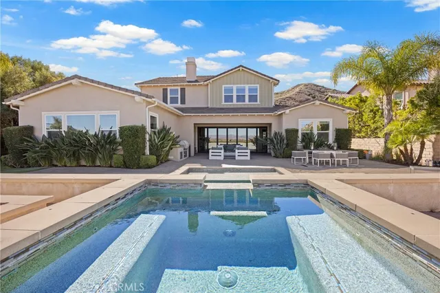 a view of swimming pool with outdoor seating and yard in the back