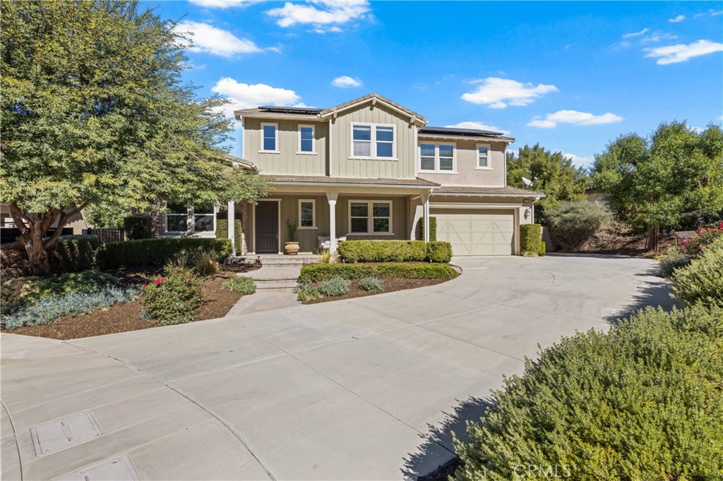 24910 Old Stone Way Stevenson Ranch, CA 91381 - Photo 5 of 67 a front view of a house with a garden