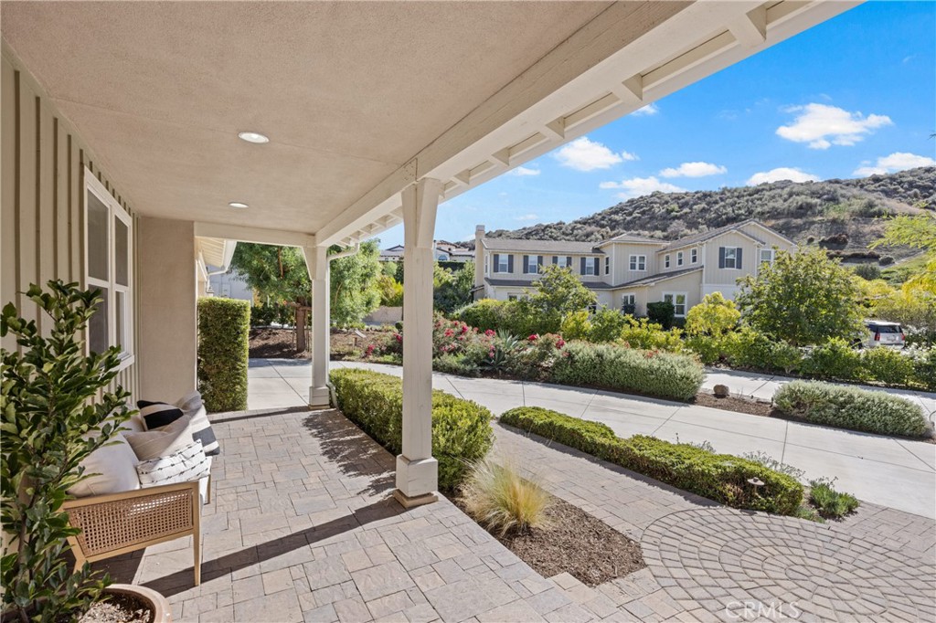 24910 Old Stone Way Stevenson Ranch, CA 91381 - Photo 7 of 67 a view of a patio with couches table and chairs and potted plants