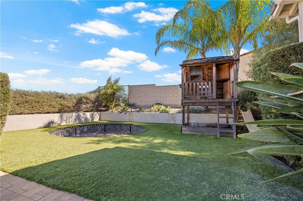 24910 Old Stone Way Stevenson Ranch, CA 91381 - Photo 8 of 67 Grassy space with trampoline space and play set