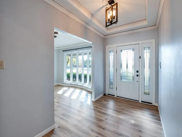 a view of an entryway with wooden floor