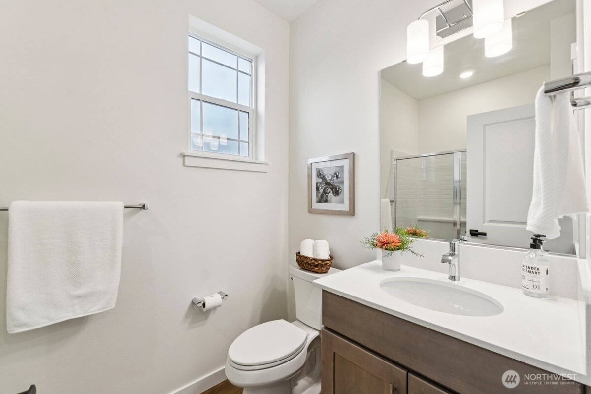 24233 13 Avenue Southeast, Unit CR26 Bothell, WA 98021 - Photo 9 of 21 a bathroom with a toilet a sink and mirror