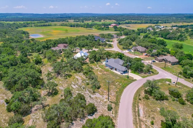 a view of a house with a yard and a garage
