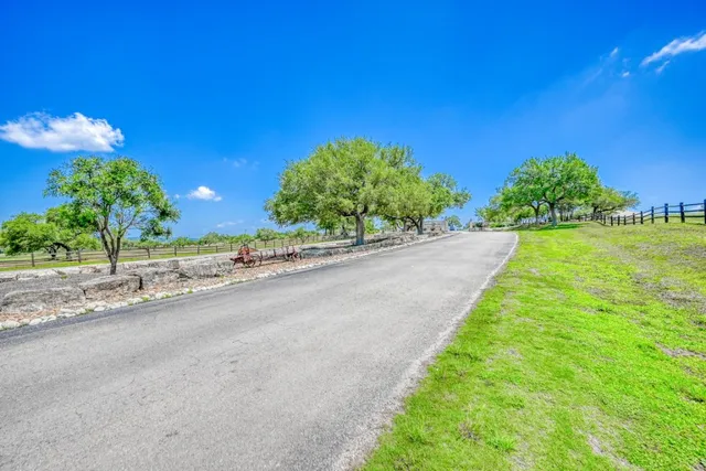 a view of a house with yard and sitting area