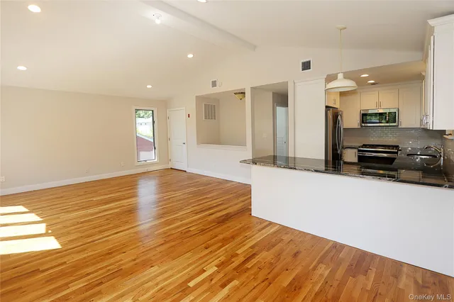 a large kitchen with kitchen island a sink stainless steel appliances and cabinets