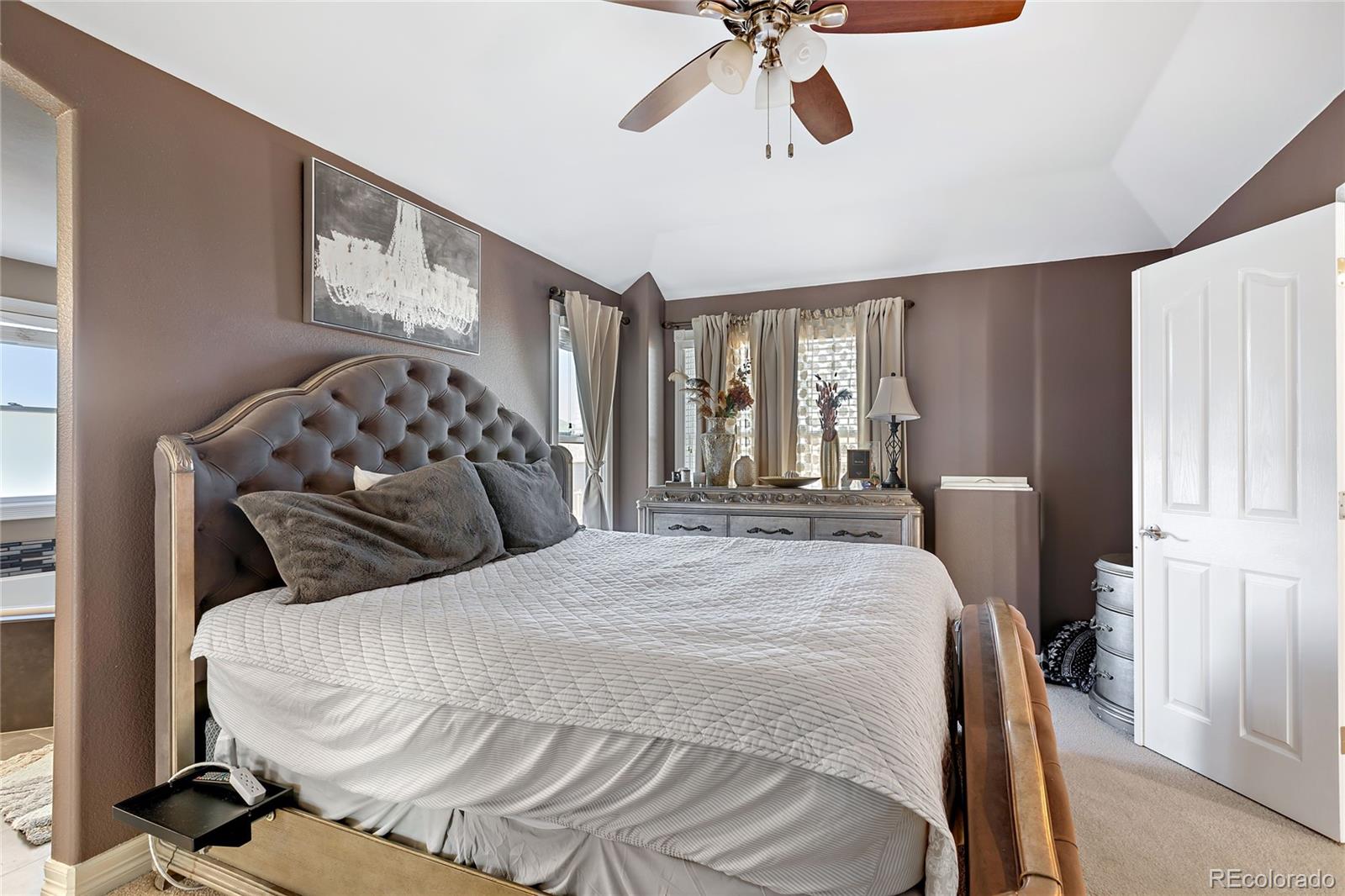 5546 Drake Street Frederick, CO 80504 - Photo 13 of 25 a bedroom with a bed and wooden floor