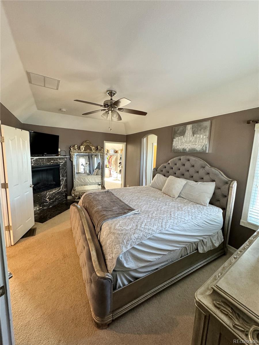 5546 Drake Street Frederick, CO 80504 - Photo 14 of 25 a bedroom with a bed and a mirror