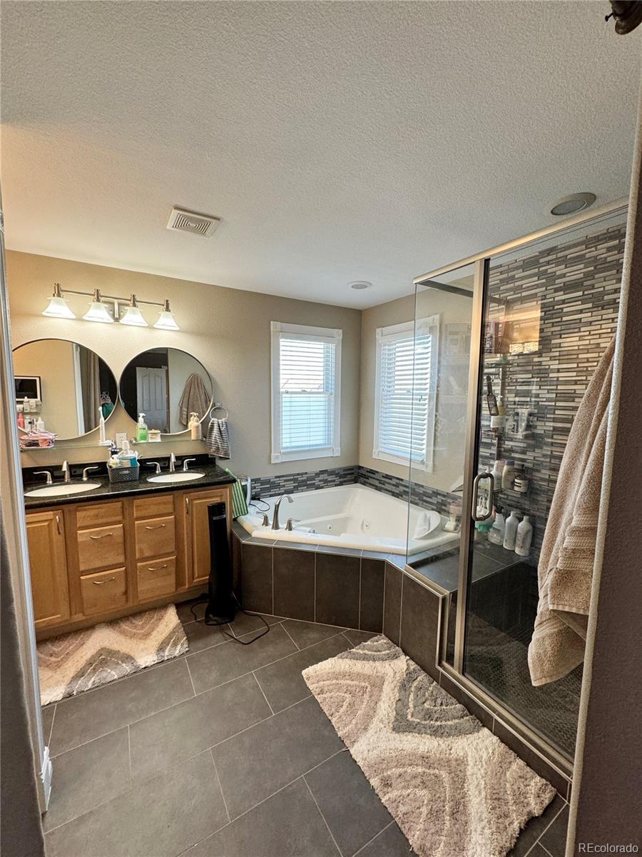 5546 Drake Street Frederick, CO 80504 - Photo 17 of 25 a kitchen with a sink stove and chairs