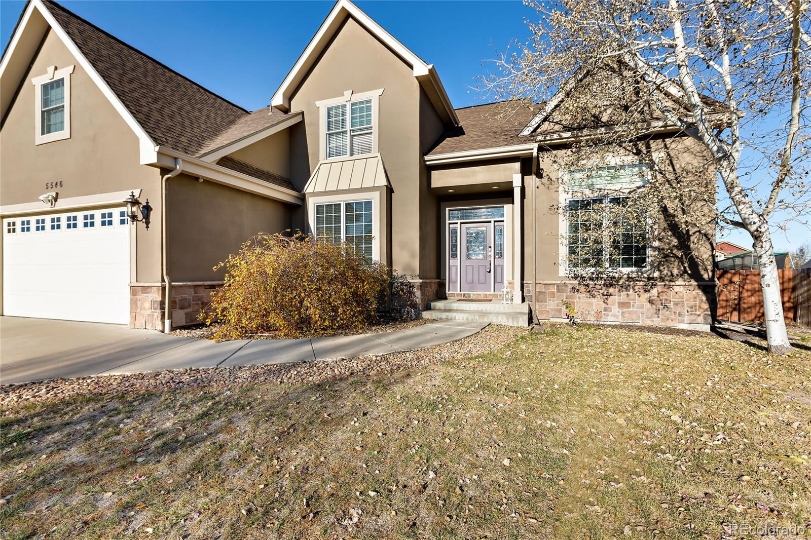 5546 Drake Street Frederick, CO 80504 - Photo 2 of 25 a front view of a house with a yard and garage