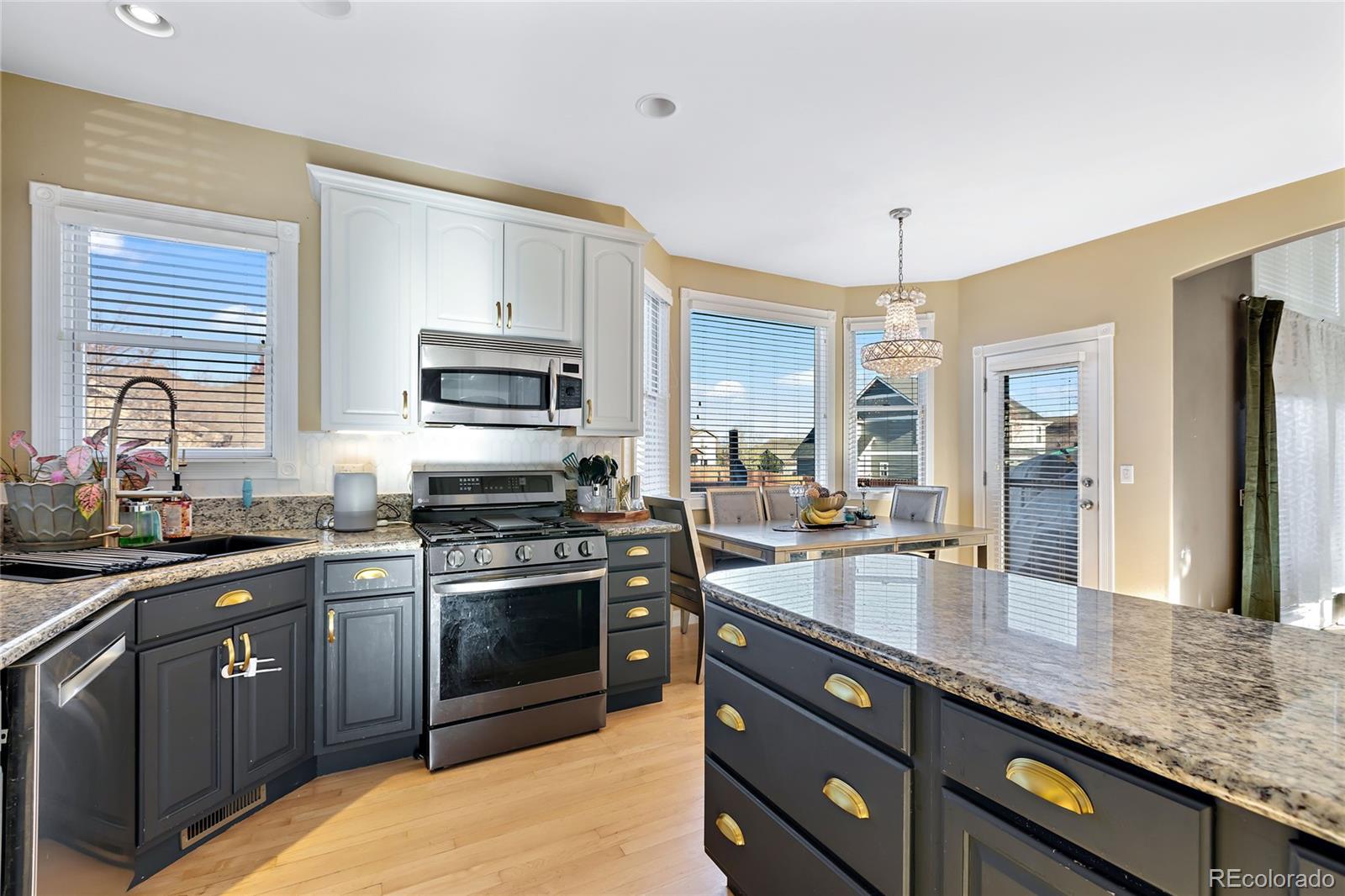 5546 Drake Street Frederick, CO 80504 - Photo 5 of 25 a kitchen with stainless steel appliances granite countertop a sink stove and refrigerator
