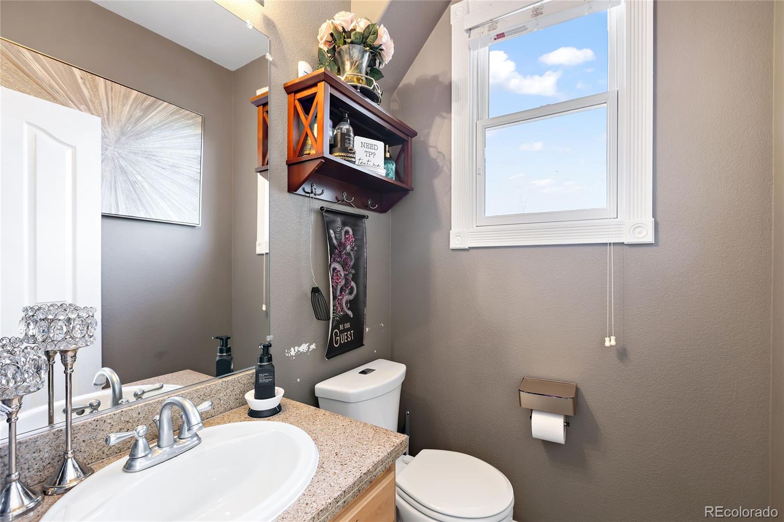 5546 Drake Street Frederick, CO 80504 - Photo 8 of 25 a bathroom with a toilet sink and mirror