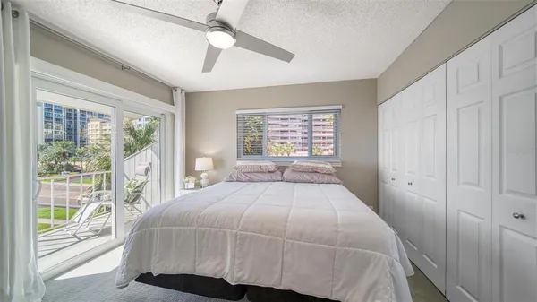 a bedroom with a large bed and a large window
