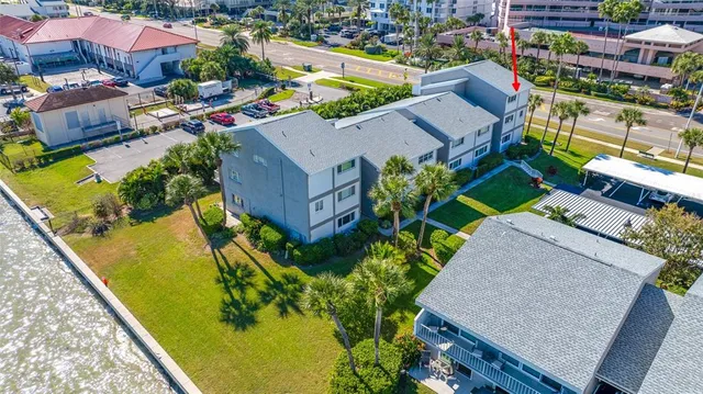 an aerial view of a house with a yard basket ball court and outdoor seating