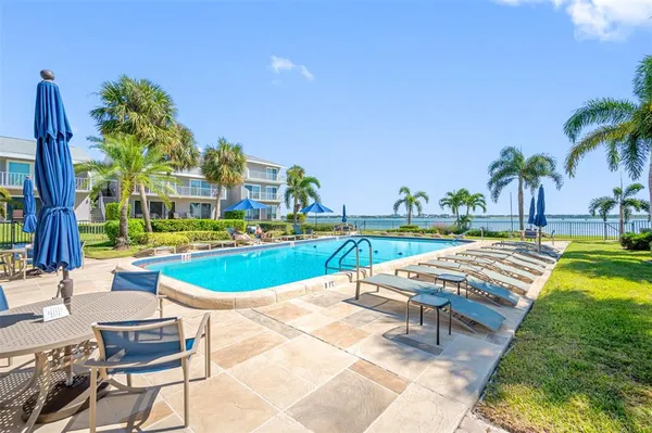 a swimming pool with outdoor seating and yard