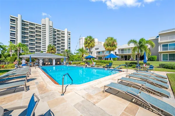 a view of a swimming pool with a lounge chairs