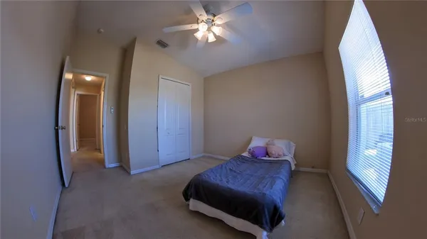 a living room with furniture and a ceiling fan
