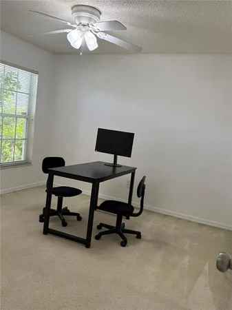 a view of a livingroom with furniture and a window