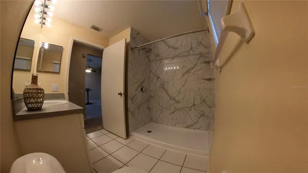 a bathroom with a shower and a sink