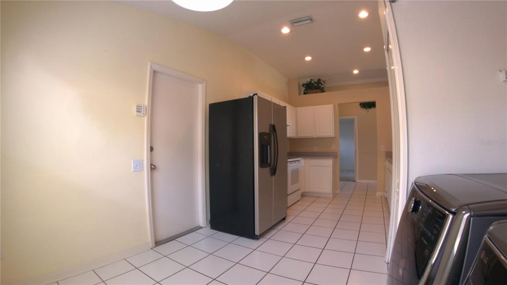 12633 Early Run Lane Riverview, FL 33578 - Photo 18 of 44 a kitchen with a refrigerator and a sink