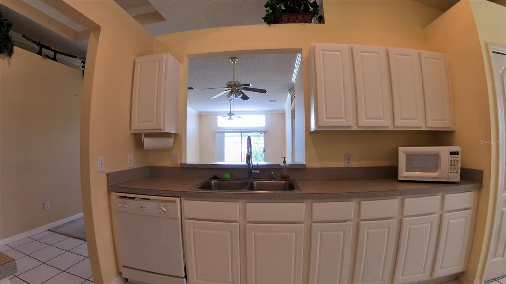 12633 Early Run Lane Riverview, FL 33578 - Photo 20 of 44 a kitchen with stainless steel appliances granite countertop a sink a stove and a granite counter tops