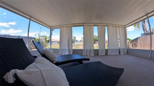 a living room with furniture and large windows