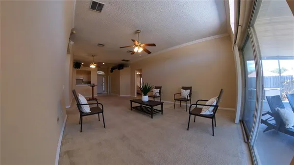 a living room with furniture and a chandelier