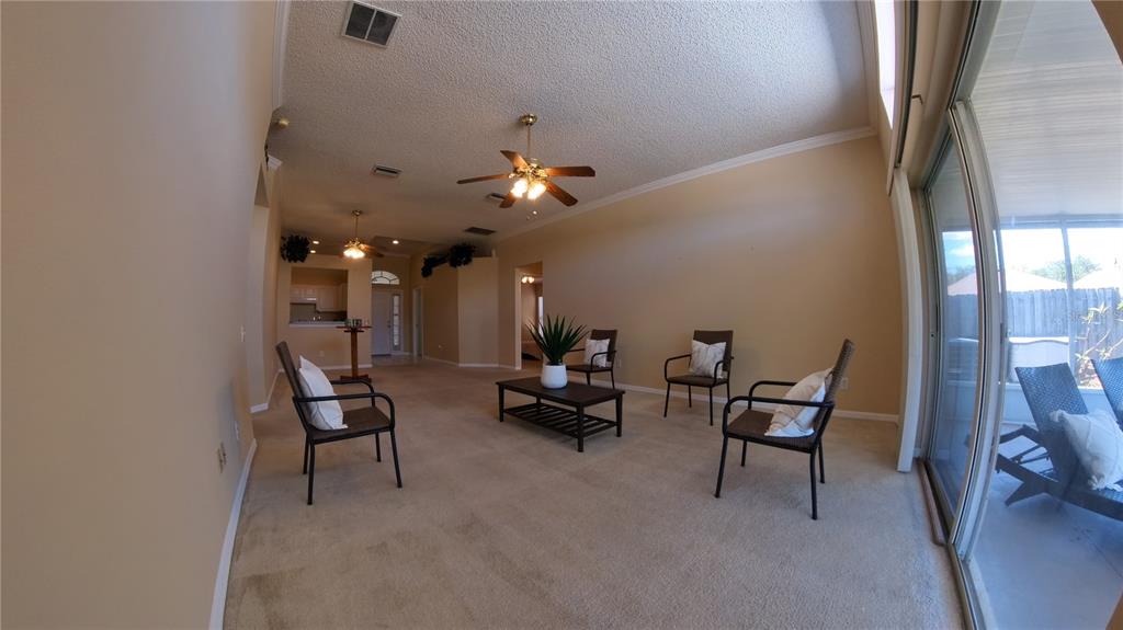 12633 Early Run Lane Riverview, FL 33578 - Photo 4 of 44 a living room with furniture and a chandelier