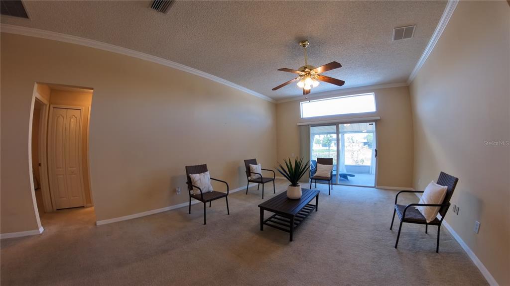 12633 Early Run Lane Riverview, FL 33578 - Photo 5 of 44 a living room with furniture a chandelier and a window