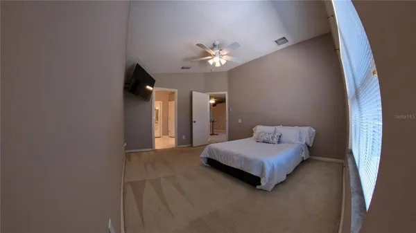 a living room with a bed furniture and a chandelier