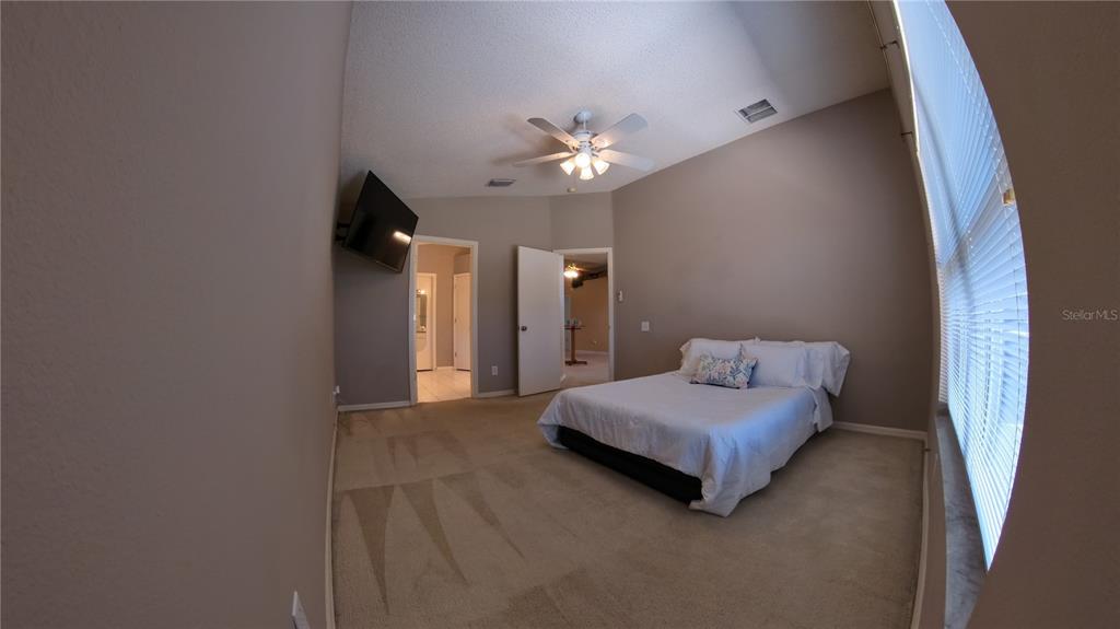 12633 Early Run Lane Riverview, FL 33578 - Photo 7 of 44 a living room with a bed furniture and a chandelier