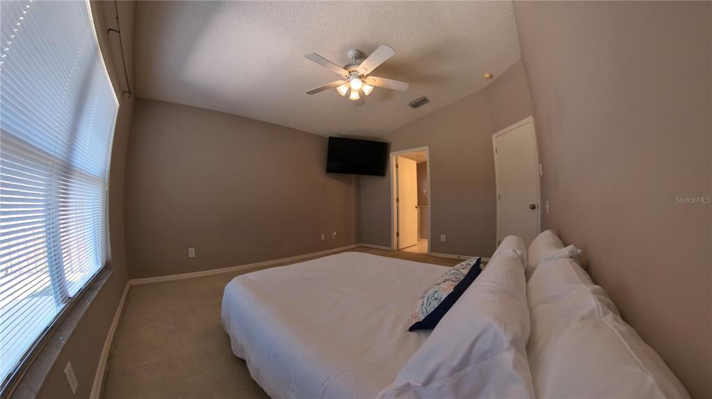 12633 Early Run Lane Riverview, FL 33578 - Photo 8 of 44 a bedroom with a bed and a ceiling fan