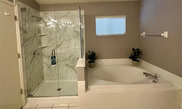 a bathroom with a bathtub and shower