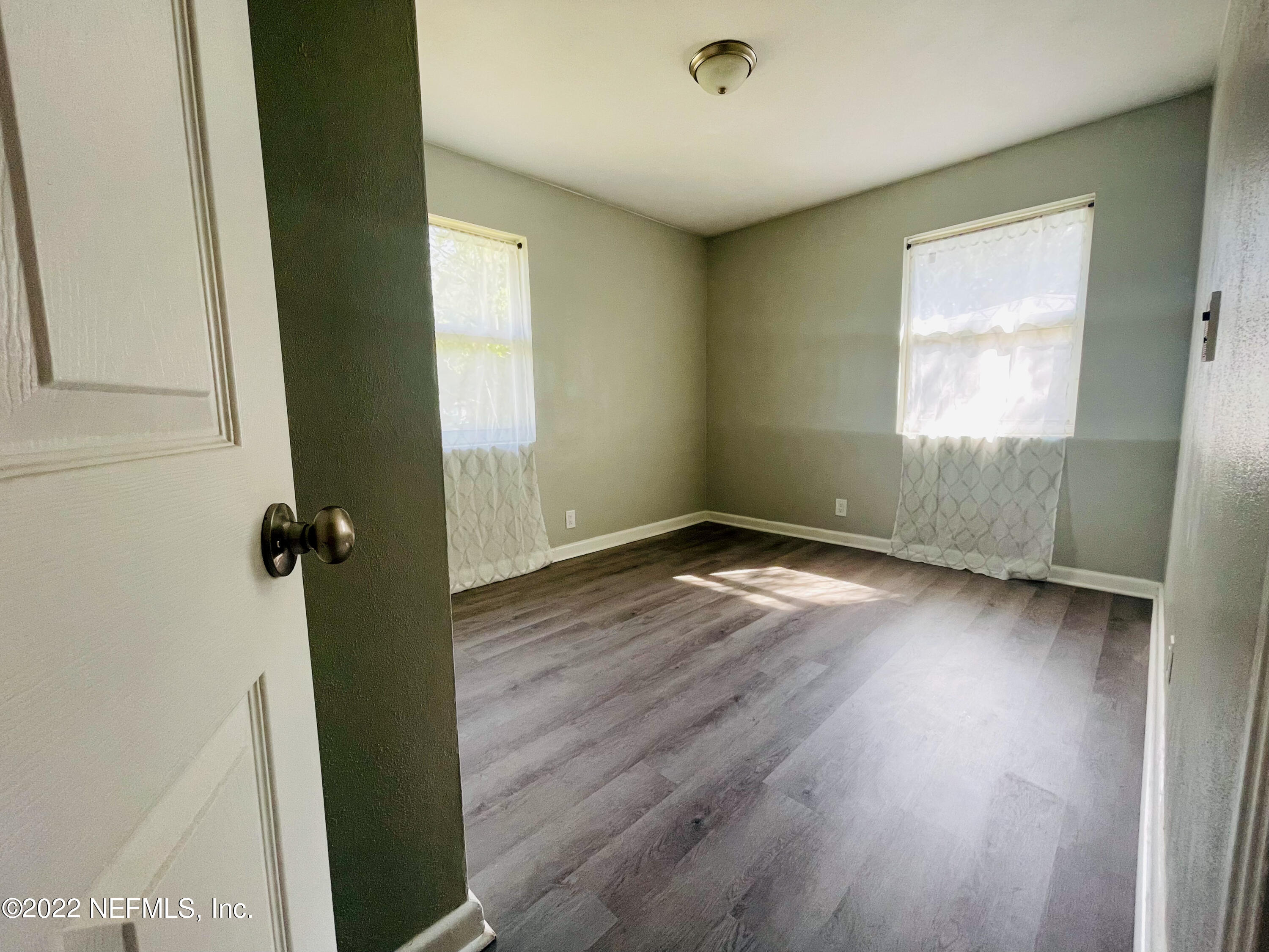 3151 Brasque Drive Jacksonville, FL 32209 - Photo 11 of 18 an empty room with wooden floor and a window