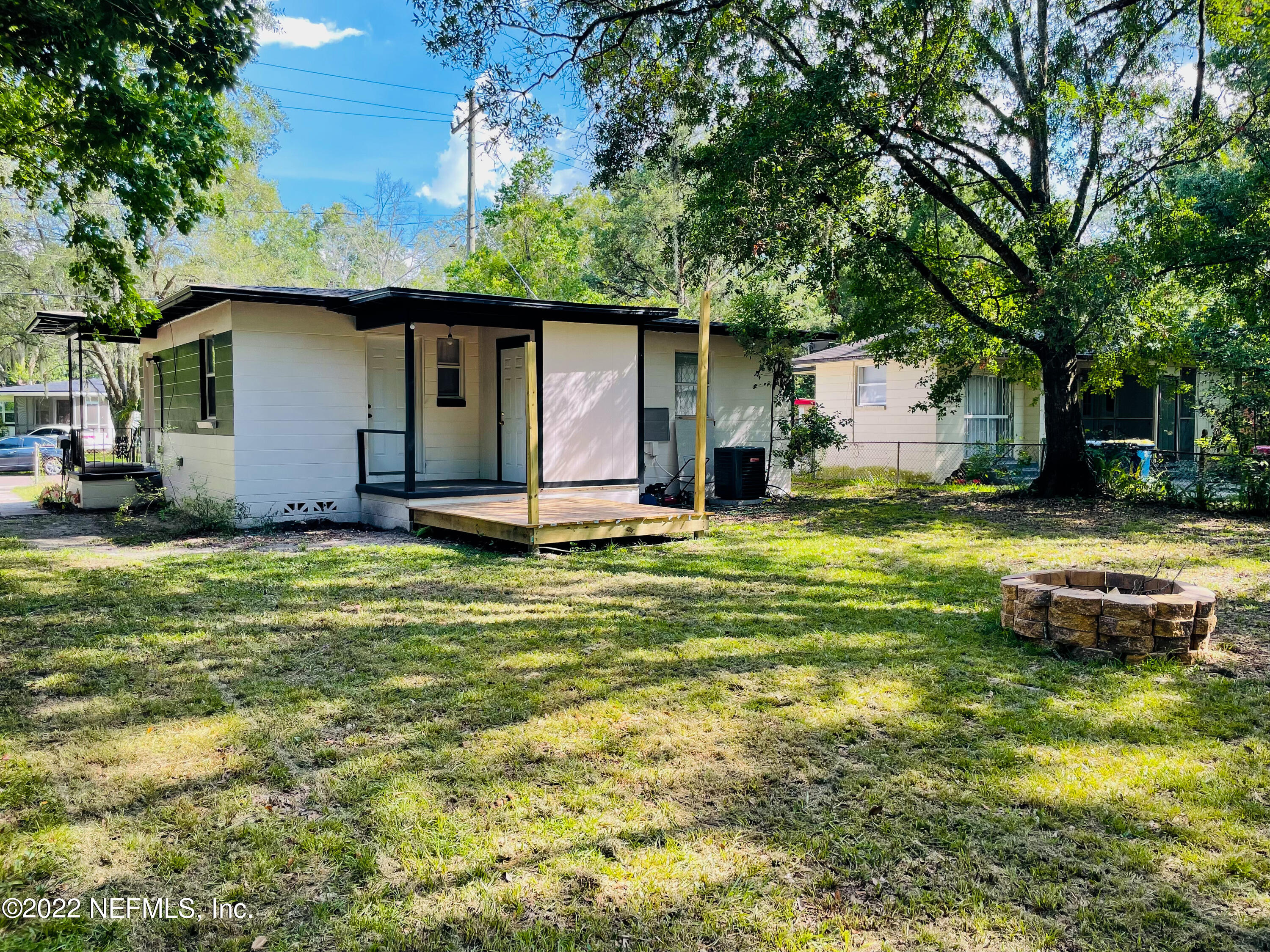 3151 Brasque Drive Jacksonville, FL 32209 - Photo 18 of 18 a front view of a house with a yard table and chairs