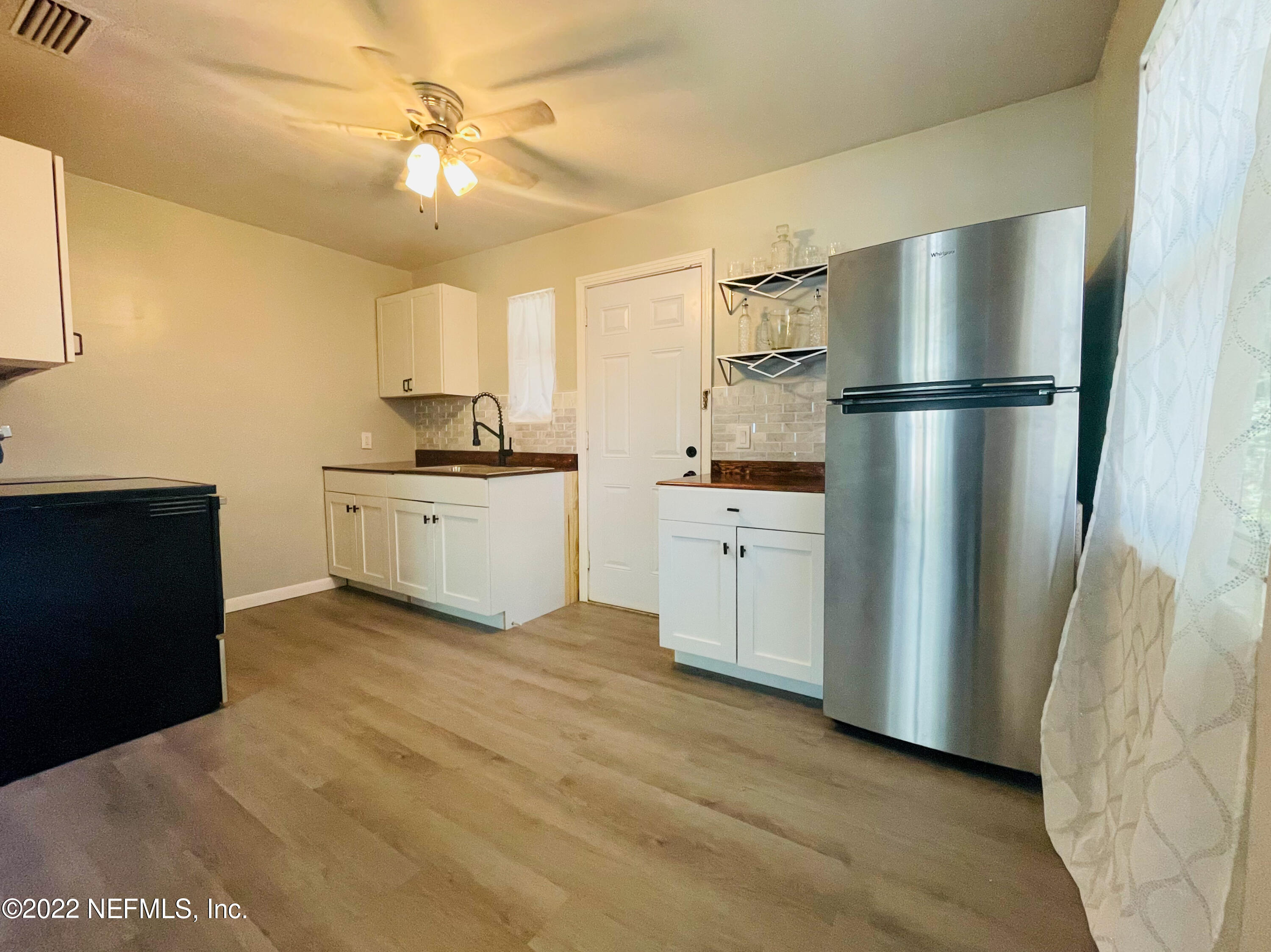 3151 Brasque Drive Jacksonville, FL 32209 - Photo 4 of 18 a kitchen with stainless steel appliances a refrigerator sink and cabinets