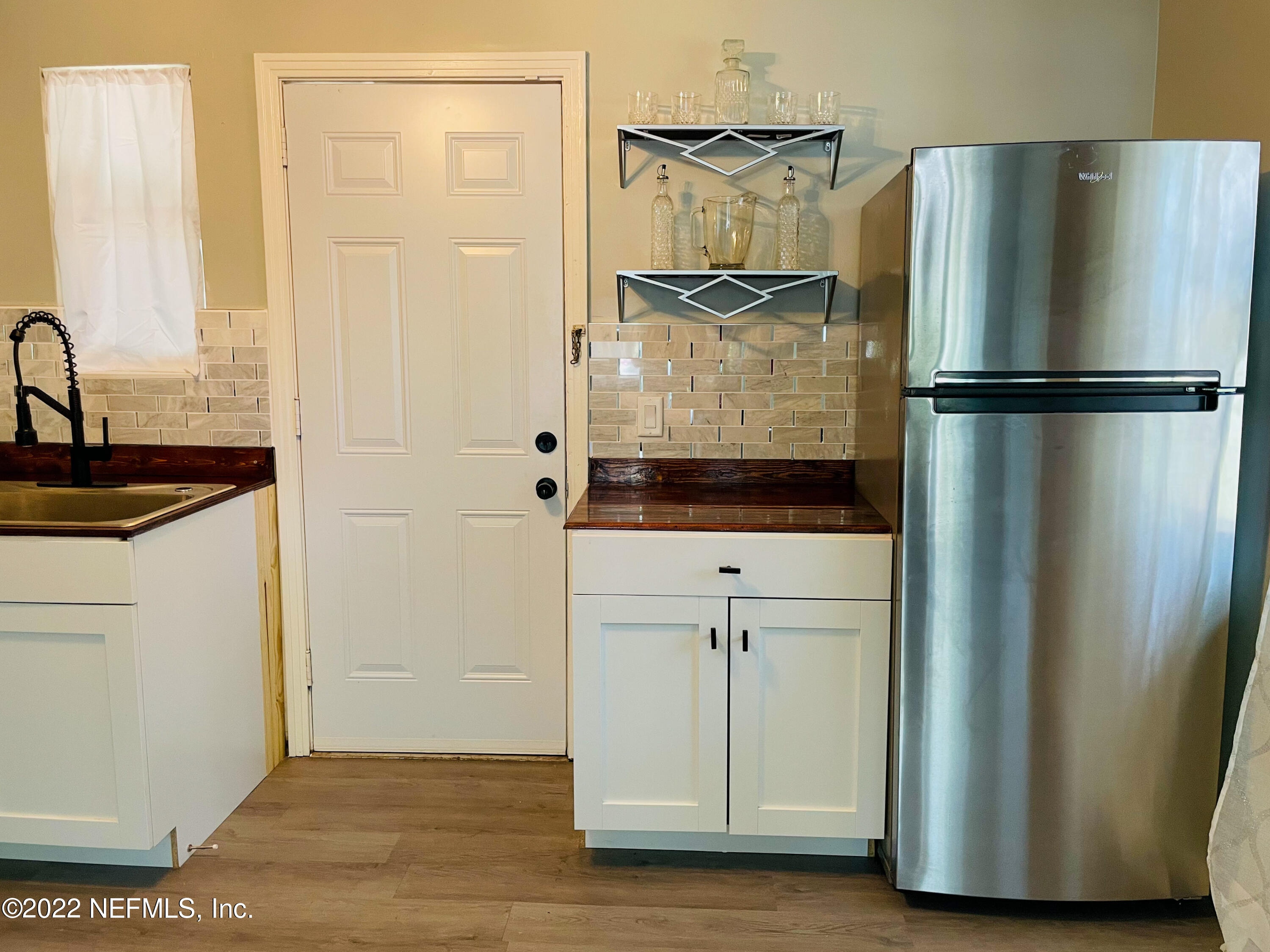 3151 Brasque Drive Jacksonville, FL 32209 - Photo 5 of 18 a kitchen with a refrigerator and cabinets